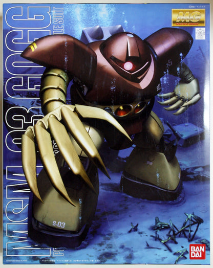 Model kit of a robot with gold and brown color scheme on a blue background